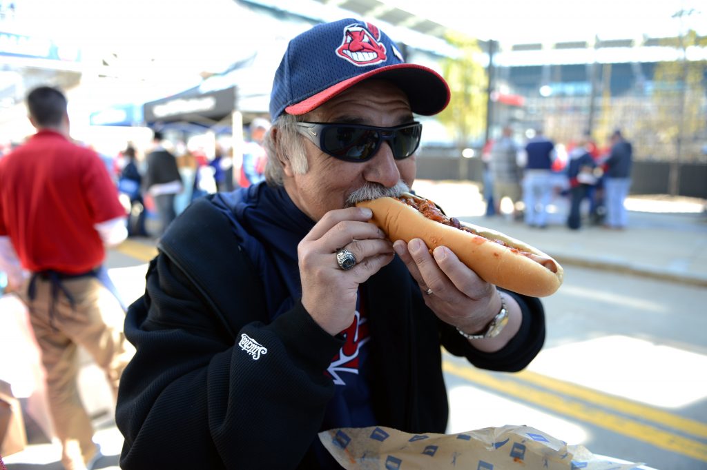 Baseball fan eating hot dog