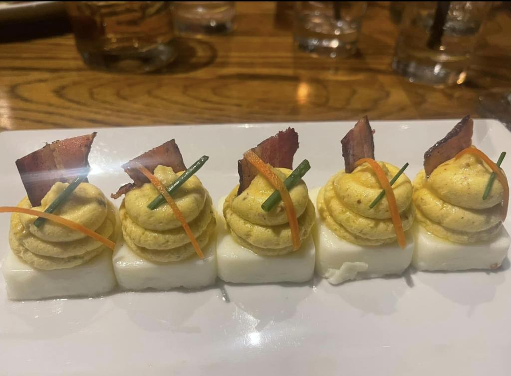 deviled eggs on a plate at burwell's stone fire grill in charleston, one of most expensive travel destinations in the U.S.